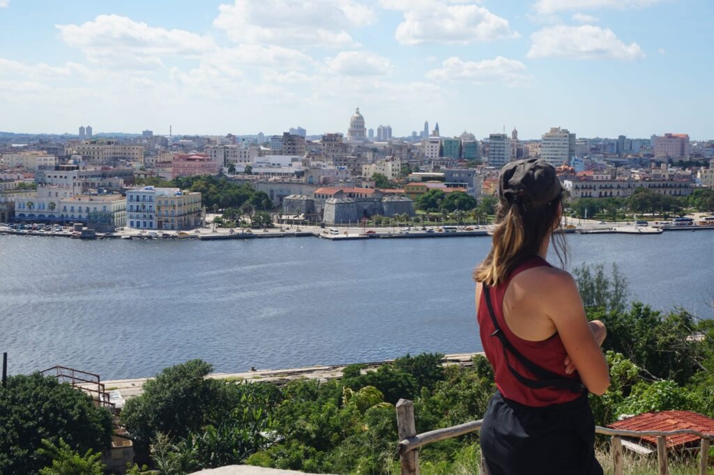 Céline está mirando la Bahía de La Habana desde el Cristo de La Habana.